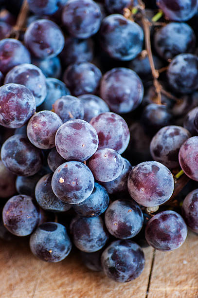 istock Grapes on a old wooden table. 471958327