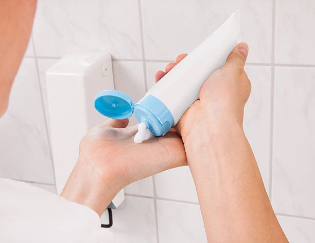 istock Young Woman Applying Cream 471958646