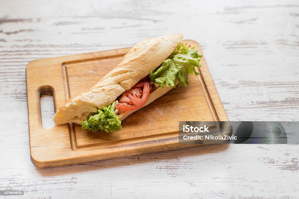 Chicken sandwich on a cutting board Chickend sandwich on a cutting board 2015 Stock Photo