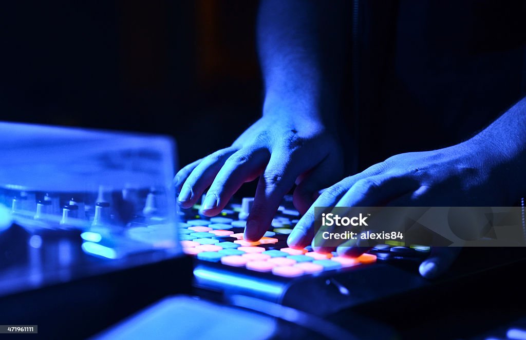 DJ's hand on audio mixer Activity Stock Photo