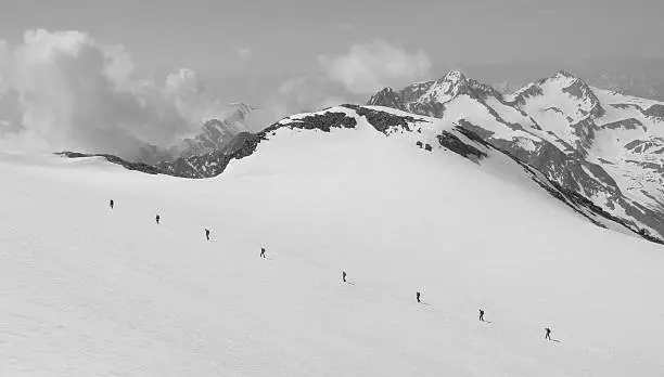 8 people ski touring up a mountain in the Austrian alps