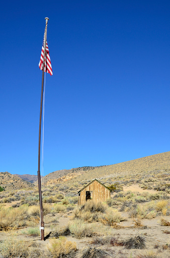 American flag by an abandoned cabin. Eastern Sierra, California.