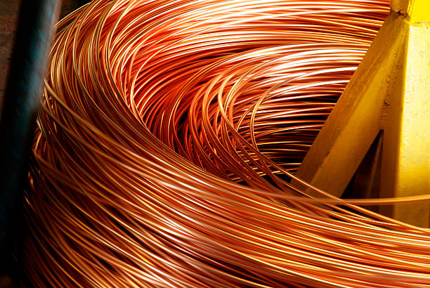 Closeup of Copper Cable being Rolled up Closeup of Copper Cable being Rolled up in Preparation for Shipment at the Factory copper stock pictures, royalty-free photos & images