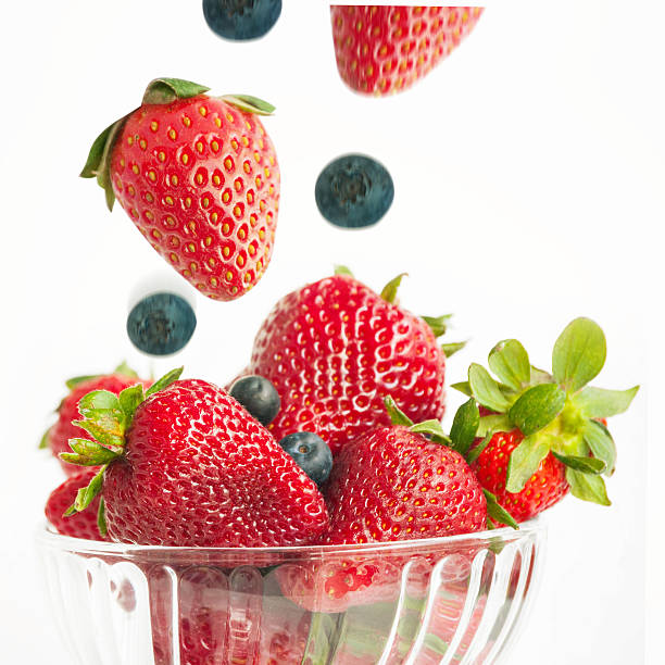 istock ripe strawberries, blueberries in glass vases 471972101