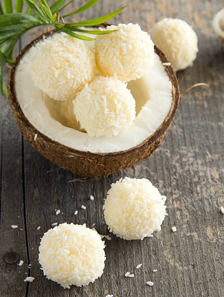 istock Coconut candy balls next to fresh coconut 471972297