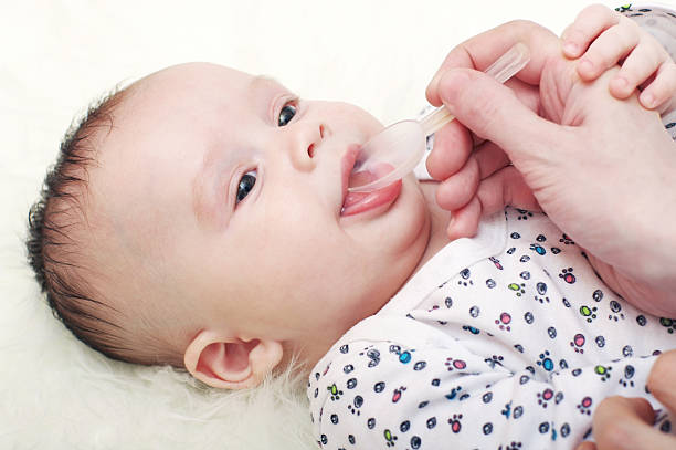 istock lovely baby drinking  juice 471972843