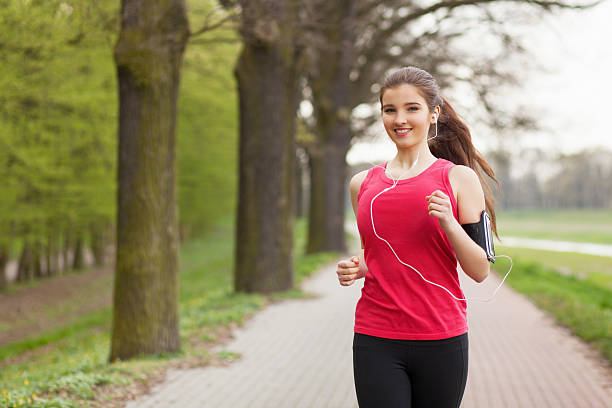 istock Young beautiful woman running on a trail 471973876