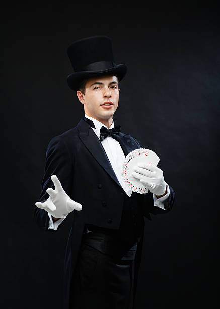 istock magician showing trick with playing cards 471974197
