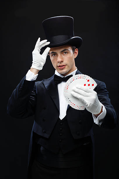 istock magician showing trick with playing cards 471974317