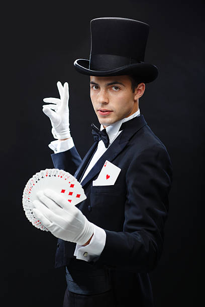 istock magician showing trick with playing cards 471974419