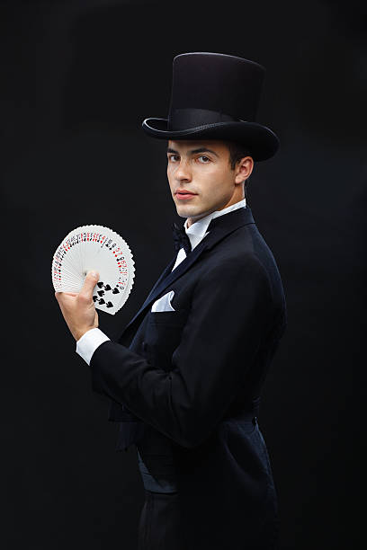 istock magician showing trick with playing cards 471974621