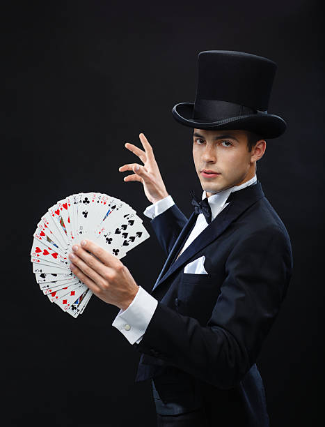 istock magician showing trick with playing cards 471974689