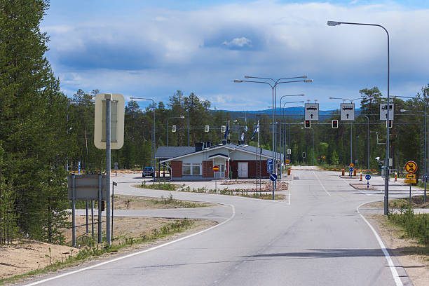 Raja-Joosepin Russian Border Crossing in Lapland, Finland. Raja-Joosepin Russian Border Crossing in Lapland, Finland. View from Lapland into Russia. No traffic under blue cloudy skies. Hidden in a forest. raja stock pictures, royalty-free photos & images