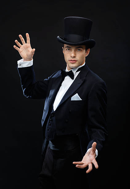 istock magician in top hat showing trick 471975461