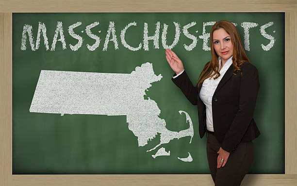 istock Teacher showing map of massachusetts on blackboard 471978135