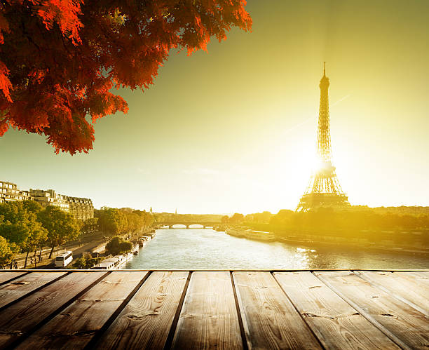 istock wooden deck table and  Eiffel tower in autumn 471978503