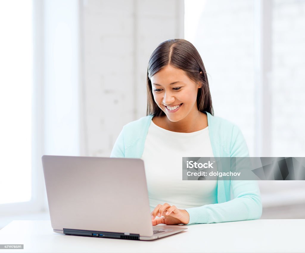 international student girl with laptop at school education concept - smiling international student girl with laptop at school Adult Stock Photo