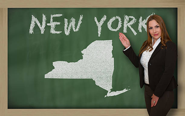 istock Teacher showing map of new york on blackboard 471979297