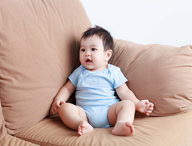 istock Thai pretty baby smiling on the sofa 471980188