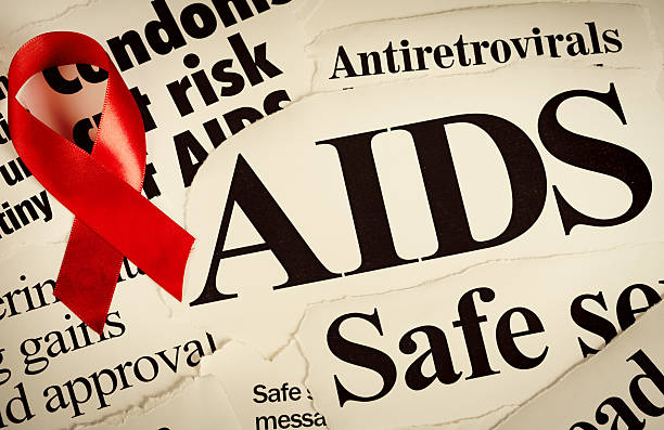 cinta roja en titulares sobre el sida - condom sex sexually transmitted disease aids fotografías e imágenes de stock