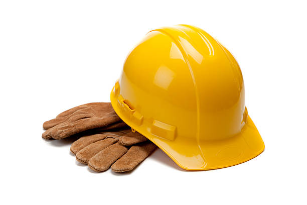 istock Yellow hard hat and leather work gloves on white 471986021