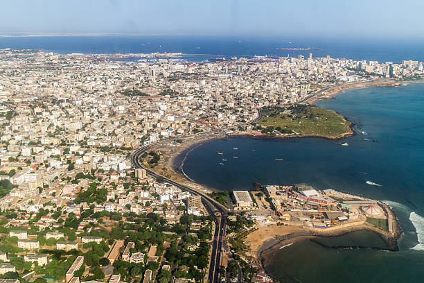 Aerial view of Dakar land and water Aerial view of the city of Dakar, Senegal, showing the densely packed buildings and a highway senegal photos stock pictures, royalty-free photos & images