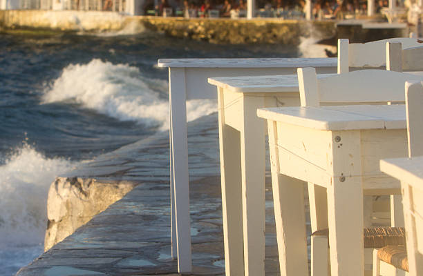 Restaurant tables with waves in the background in Little Venice