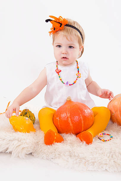 istock Baby with pumpkins 471986927