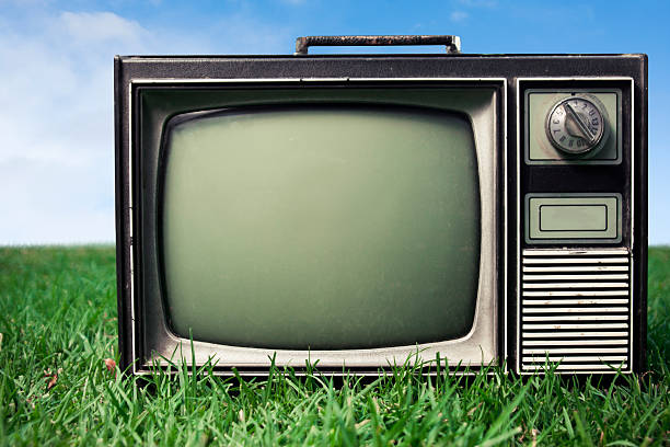 istock Close up of Retro Tv on grass 471987513