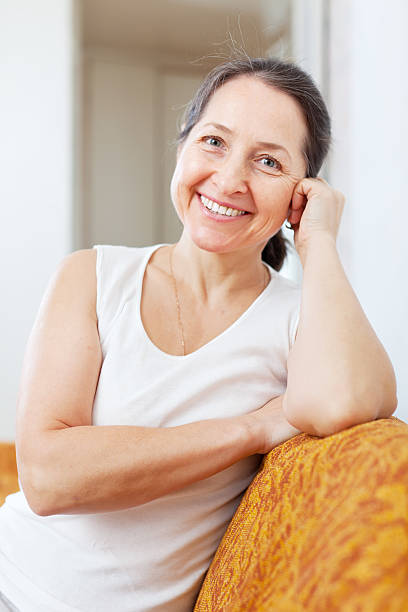 istock smiling mature woman in home 471988831