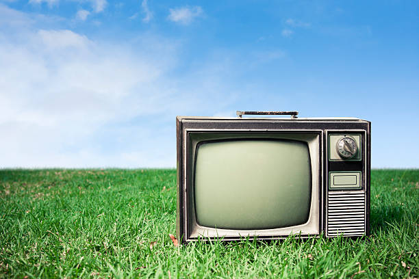 istock Close up of Retro Tv on grass 471989649