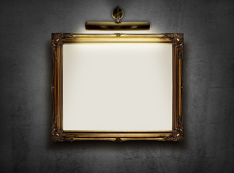 Picture frame with blank canvas hanging on a wall in an art museum