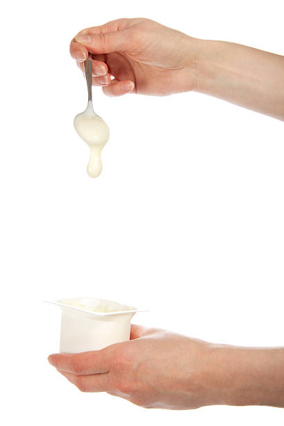 istock The hand holding a spoon with yogurt 471989841