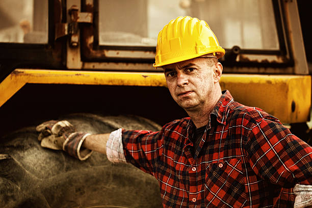 istock excavator operator in front of his vehicle 471990247