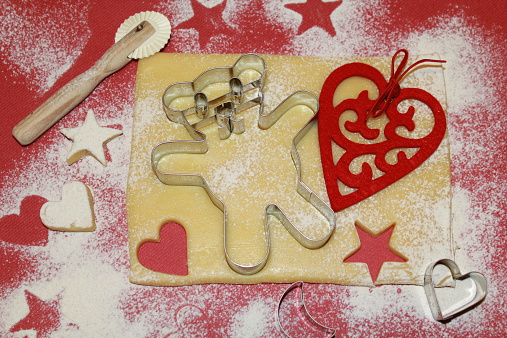 Preparing cookies for christmas with bear cutter and heart
