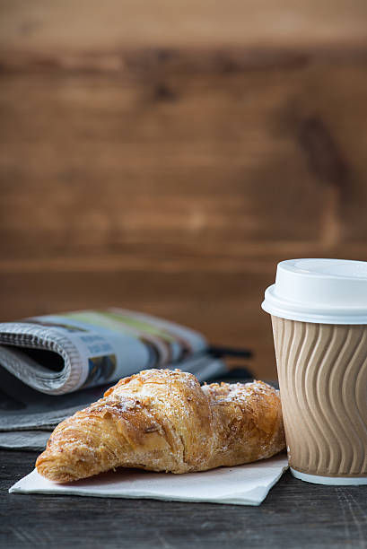 istock Take away coffee and fresh croissant and newspaper 471990908