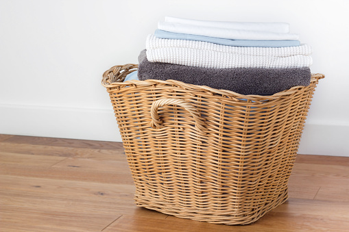 wicker basket full of clean folded laundry.