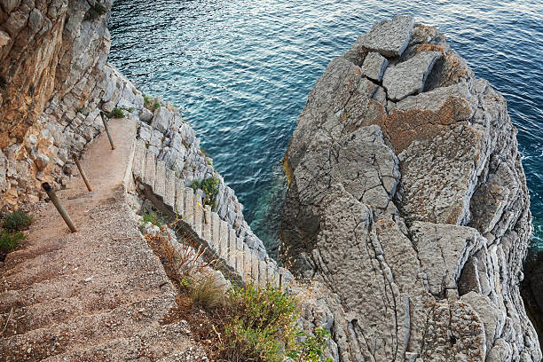 istock Old stone stairs goes down to sea water 471993141