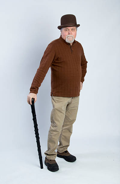 istock Elderly Irish gentleman leaning on a black walking stick 471995388