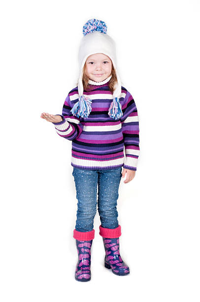 istock Little girl in winter clothes with empty hand 471995401