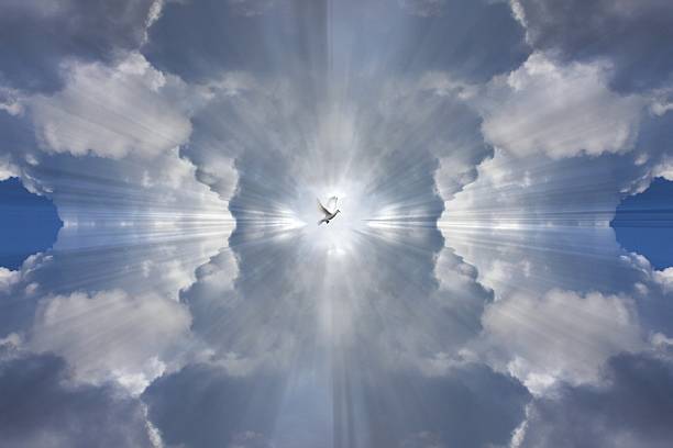 Mirrored clouds and light rays representing the Holy spirit stock photo