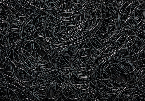 Background covered with a pile of electric cords filling the entire frame