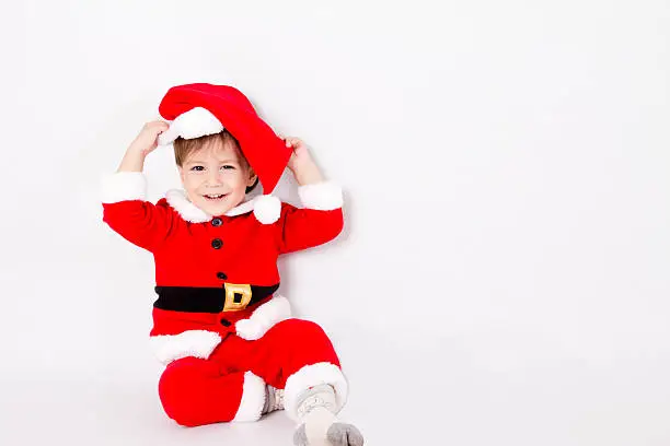little boy with Santa costume on white background