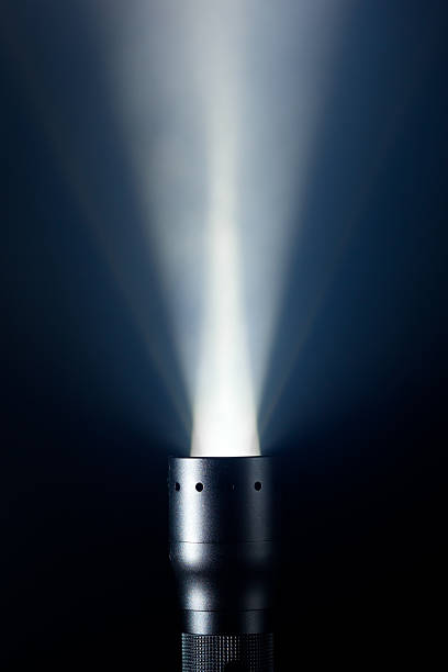 istock Profile of the top of a flashlight shining through the dark 471998623