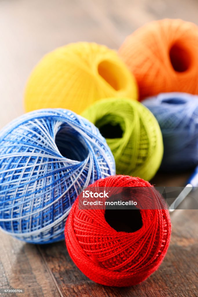 Colorful yarn for crocheting and hook on wooden table 2015 Stock Photo