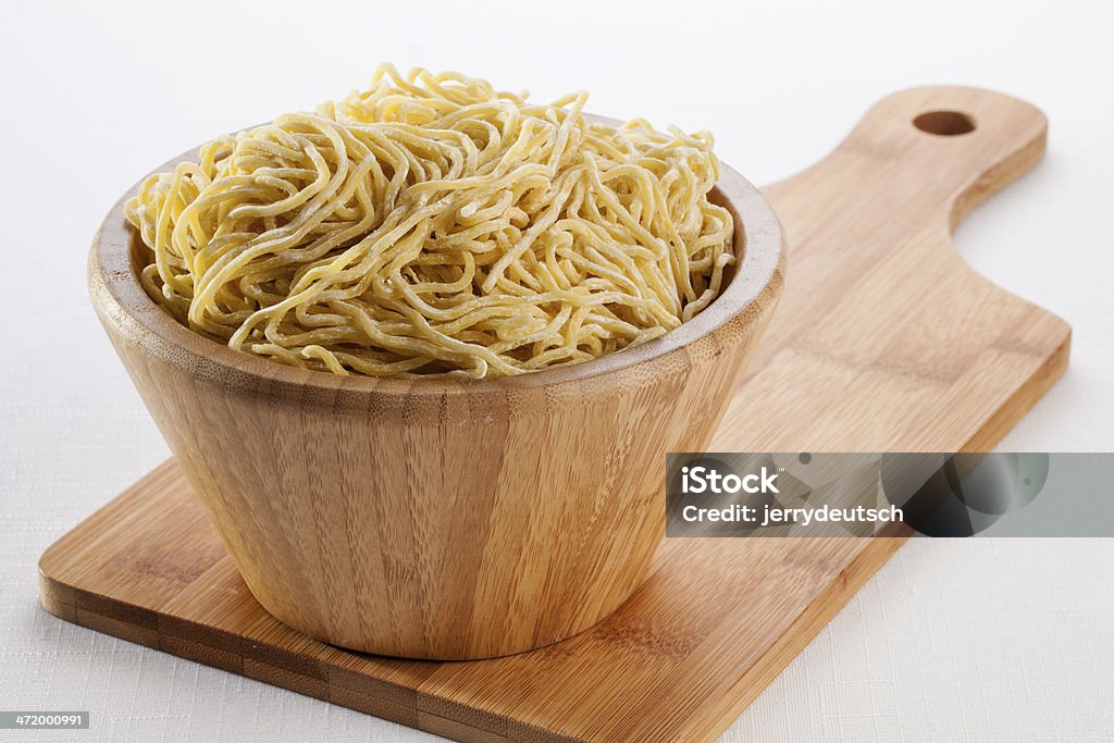 Bowl of Ramen Noodles on a cutting board A bowl of Ramen Noodles ready to be cooked. Asian Culture Stock Photo