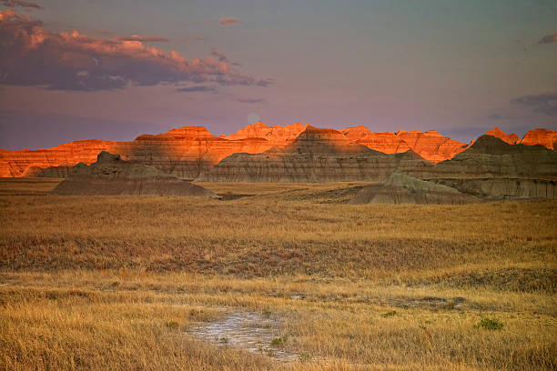 Morning Light Touching the Top of the Mountains USA, South Dakota, Badlands National Park. Morning Light Touching the Moon and the Top of the Mountains. badlands stock pictures, royalty-free photos & images