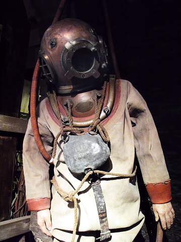 Old antique, deep-sea diving suit with a brass helmet