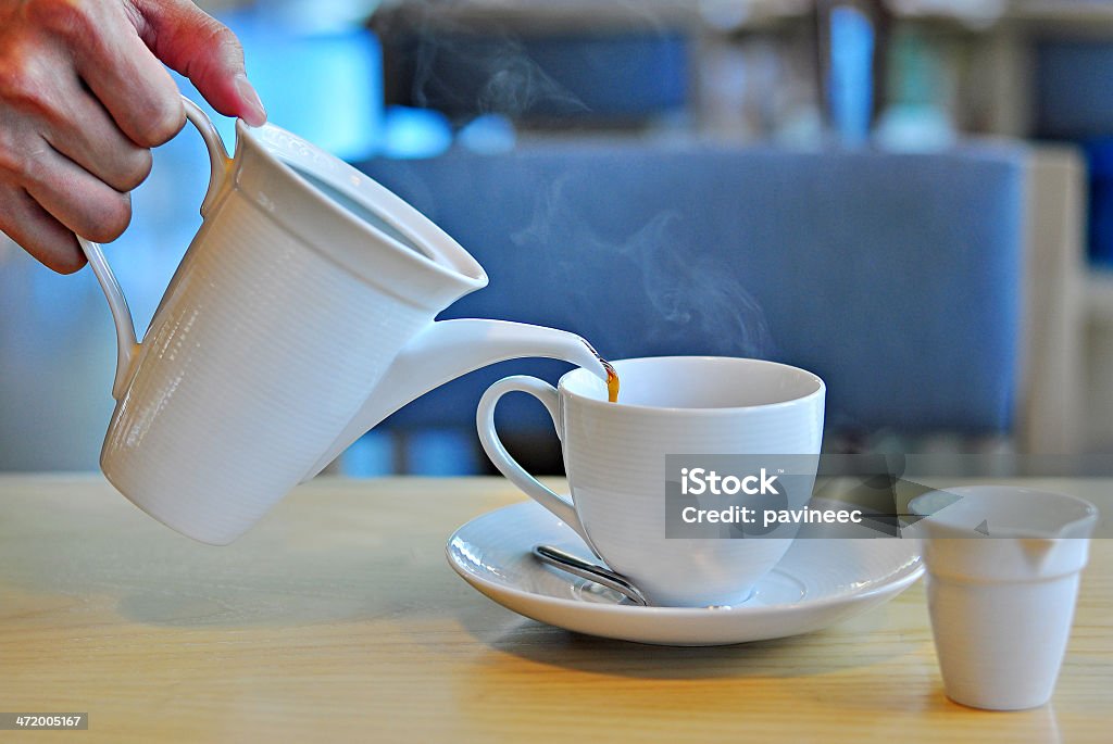 Pouring coffee into a cup Close up of a man pouring coffee into a cup Adult Stock Photo