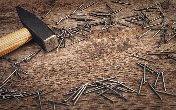 istock metal Hammer and nails on wooden board 472007342